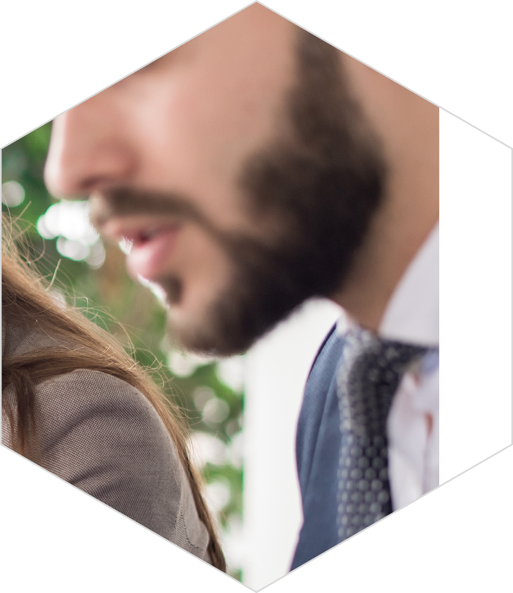Portrait of two modern business people discussing documents in office, focus on beautiful young woman reading text